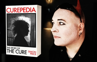 Simon Price is pictured to the right of the image, he has a black shirt on, black eyeliner and black sunglasses up on his head, he is looking over towards an image of his book, Curopedia which is pictured left.