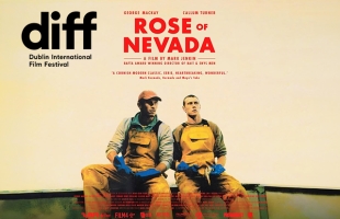 Nick (1917’s George MacKay) and Liam (Callum Turner), sit outside in a open boat, they both have worried, confused looks on their faces.