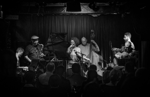 A group of musicians on stage performing