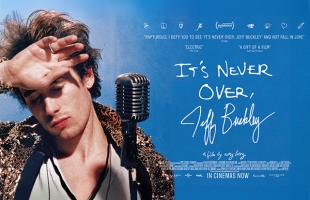 Poster-style image of a young male singer standing at a vintage microphone, eyes closed and hand raised to his forehead as if shielding light. He wears a textured jacket and looks introspective. Blue background with handwritten-style title text reading “It’s Never Over, Jeff Buckley,” along with film quotes and release information.