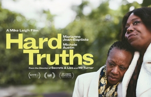 Poster for Hard Truths with the title to the left of the image, to the right are two Afro-Caribbean women. One, with tears in her eyes, is resting her head on the shoulder of the other.