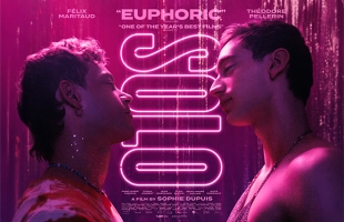 Poster for Solo. Théodore Pellerin and Félix Maritaud stand shirtless looking at each other, illuminated by a pink neon glow.