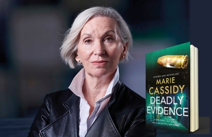 Marie Cassidy, wearing a black leather jacket, stands with her arms crossed