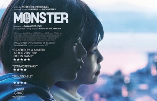 Poster for Monster, with the two young boys who serve as the main characters in profile, staring out across a large city.
