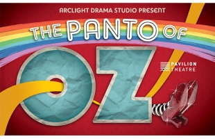 Poster for The Panto of Oz presented by Arclight Drama Studio at Pavilion Theatre. The title features a large blue “OZ” with a yellow brick road curving through it, a rainbow overhead, and the Wicked Witch’s striped legs and red shoes peeking out from the side on a red background.