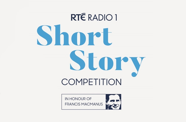 Waist-up short of Seán Rocks with his arms folded, looking very handsome.