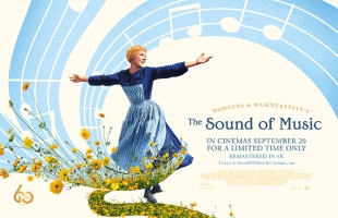 Poster for The Sound of Music. Julie Andrews, dressed in a black dress and gingham pinafore, with arms outstretched, with flowers surrounding her