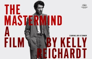 Poster for The Mastermind. Josh O'Connor, dressed in an ill-fitting suit stands with his shoulders slumped.