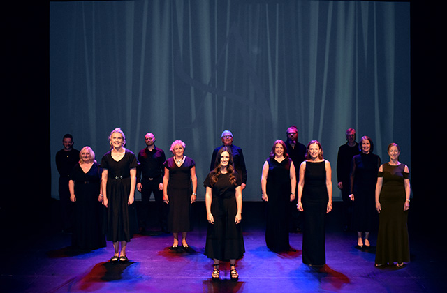 The Aurora Choir, all dressed in black