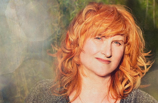 Eddi Reader in the bright sunshine, smiling at the camera