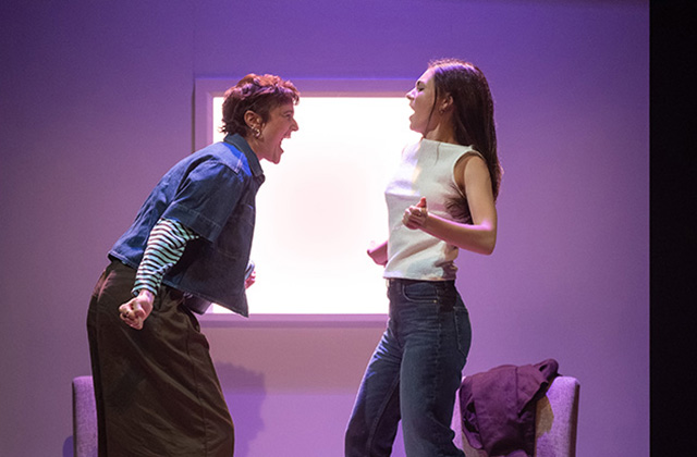 For Dolores production images. Mo and Réaltín are dancing together on stage. It's energetic and they are mid movement against a purple background.