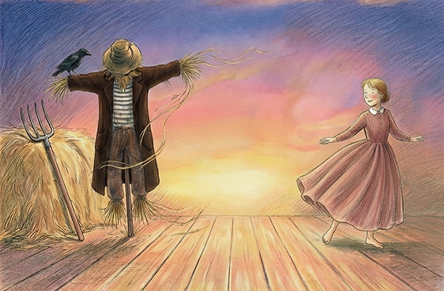 An illustrated scene at sunset on a wooden platform or barn floor. On the left, there’s a scarecrow in a brown coat and straw hat with a black crow perched on its outstretched arm. A pitchfork leans against a haystack nearby. On the right, a young girl in a long pink dress dances or twirls with her arms open, smiling toward the scarecrow. The sky behind them is softly coloured in pink, purple, and golden light.