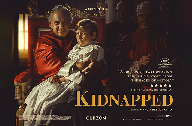 Poster for Kidnapped, a young boy in white is being held on the lap of a Catholic Cardinal, dressed in red, who sits on an elaborate chair.