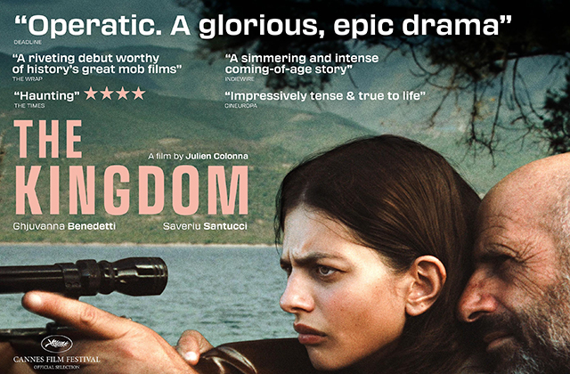 Poster for The Kingdom. A young woman holds the scope of a rifle up to her eye, while an older man leans into her, seemingly giving her guidance