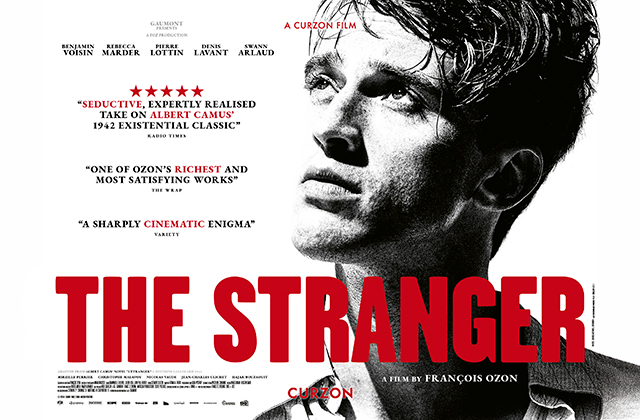 Alt text:   Film poster for *The Stranger*. A black-and-white close-up portrait fills the right side, with the face partially cropped. On the left, white space contains review quotes and cast names. Large red block lettering across the bottom reads “THE STRANGER.” Smaller text credits François Ozon as director, with festival laurels and critical praise above.