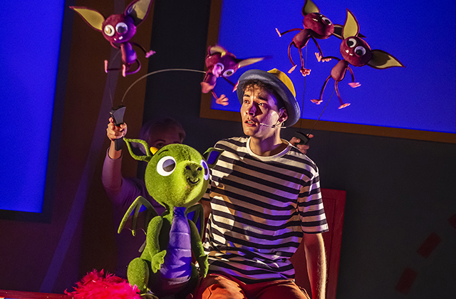 One of the cast looks pensive as he is surrounded by lots of little monster who have appeared