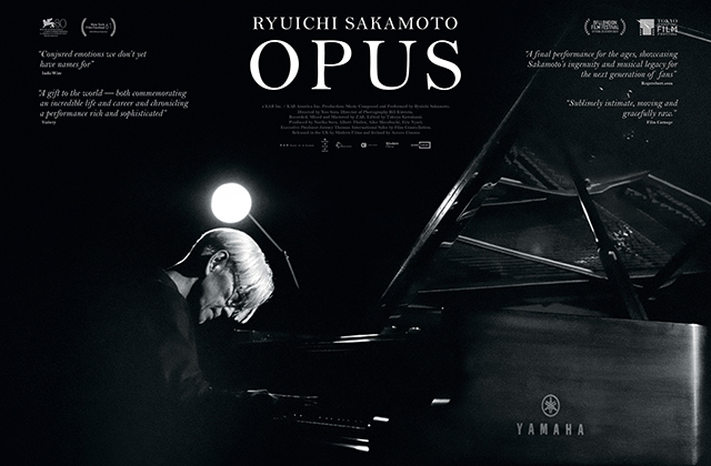 An faint, close, black-and-white headshot of Ryuchi Sakamoto wearing glasses, superimposed over a wide shot of Sakamoto sat in a large studio playing a grand piano.