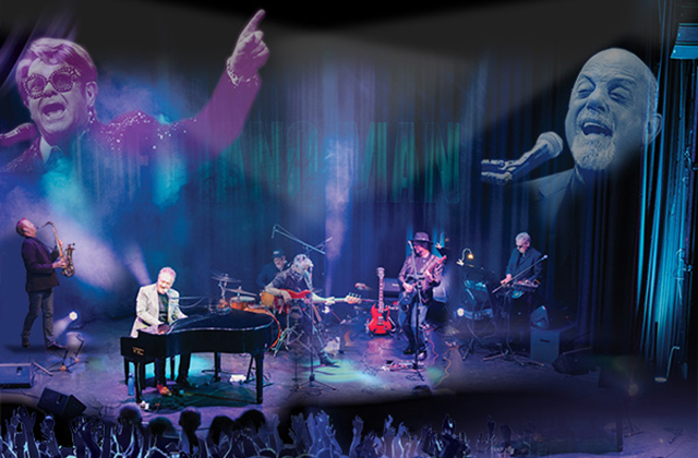 John Forde sits on stage at the piano alongside The 52nd Street Band, there is a bluey purple lighting and an image of Elton John & Billy Joel is projected behind them.