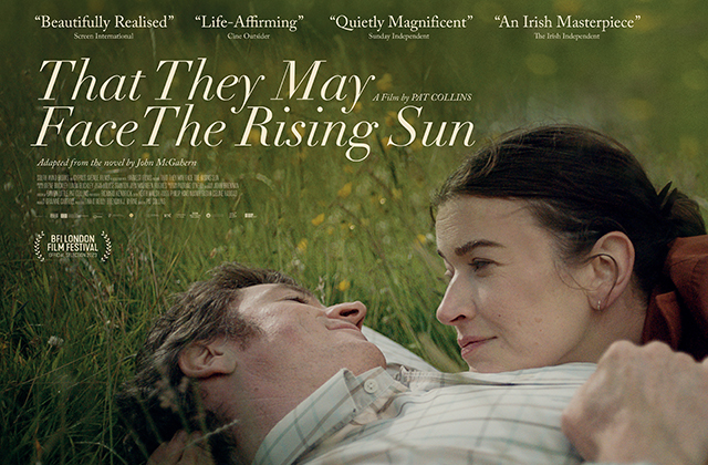 Poster for That They May Face the Rising Sun, Barry Ward lying in a grass field looking down at Anna Bederke resting her head on his chest, and looking up at him.