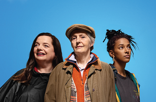 Helen Norton, Jane Brennan and Fanta Barrie, smiling against a blue sky background.